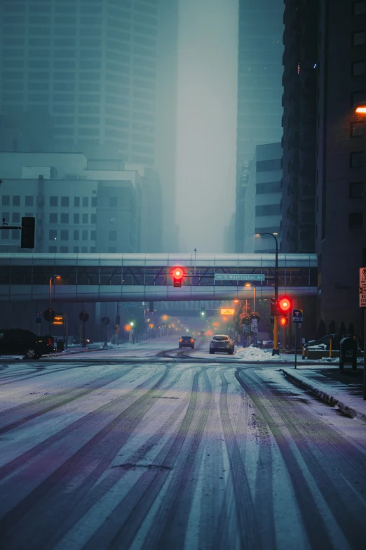 an intersection at a crosswalk covered in snow