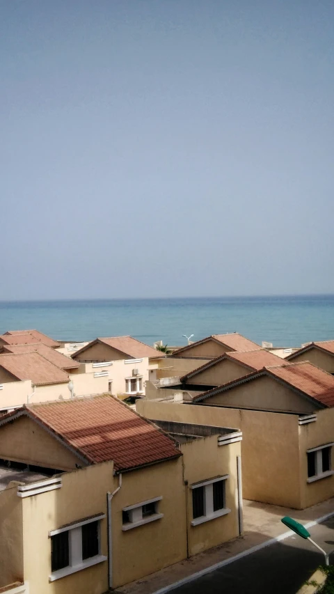 houses along the beach with water in background