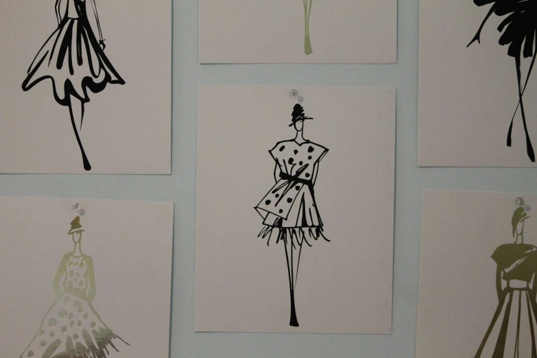 dresses are drawn in black and white on paper