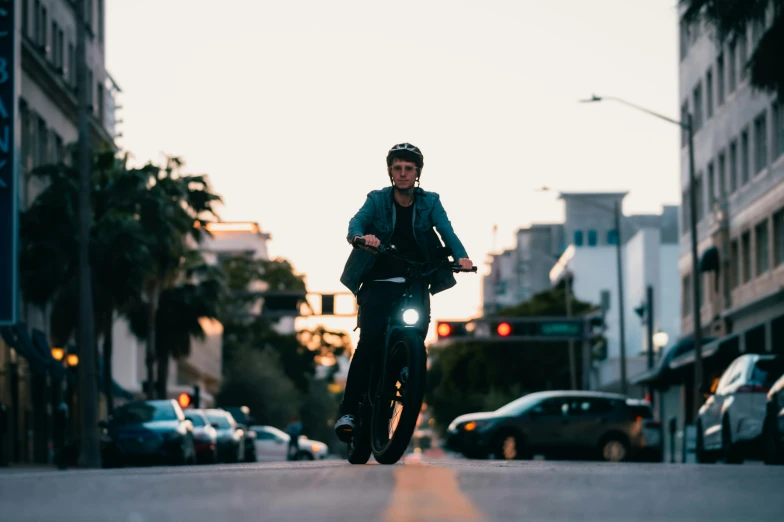 the man is riding his bike down the street