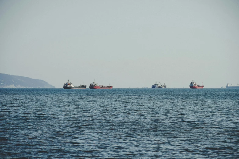 five ships out in the ocean with each other