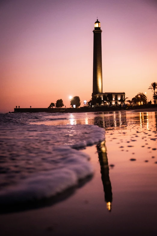 there is a tall lighthouse near the ocean