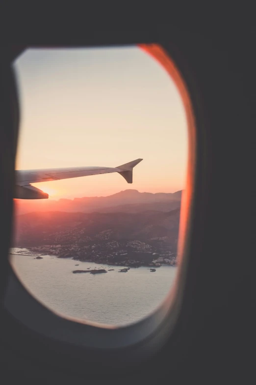 an airplane window overlooking a large body of water