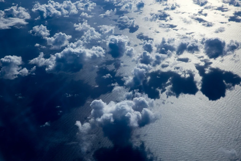 an image of many clouds seen out an airplane window