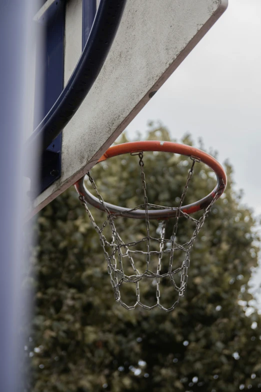 the net is hanging off the basketball hoop