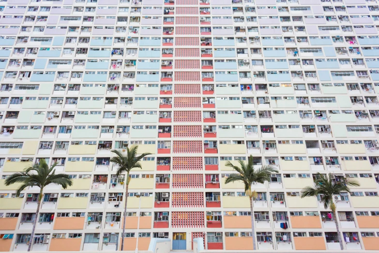 people looking down from windows at a tall building