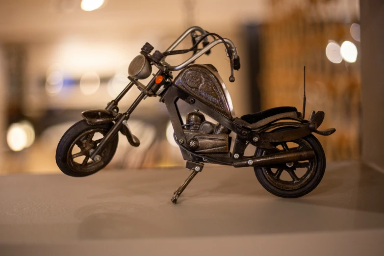 a miniature motorcycle is shown in this dark po