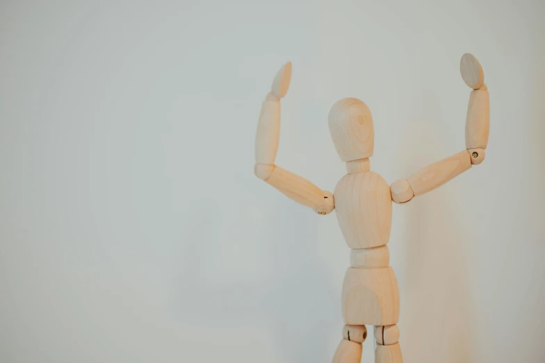 an action figure standing and holding up two hands