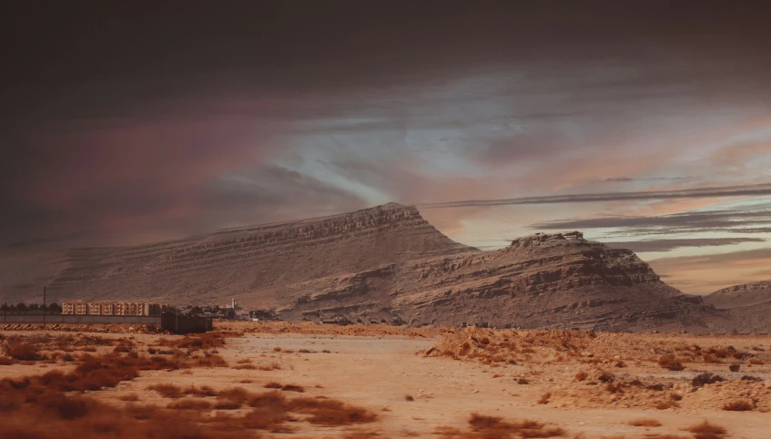 the train is going through the desert during the sunset