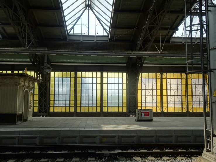 a train station with large windows and a covered platform