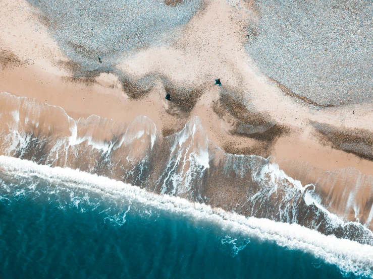 a beach with lots of small shells in the sand