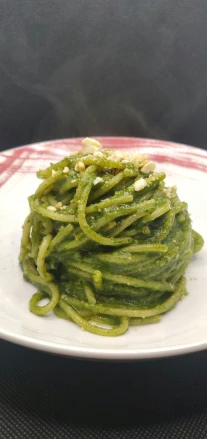 a plate with a mound of green vegetable
