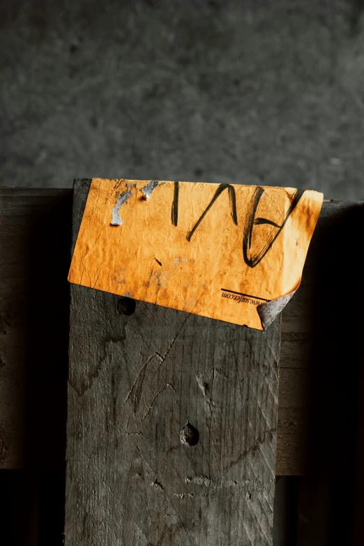 an old piece of wood has writing on it