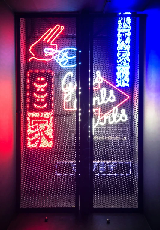 a neon sign with various asian writing on it