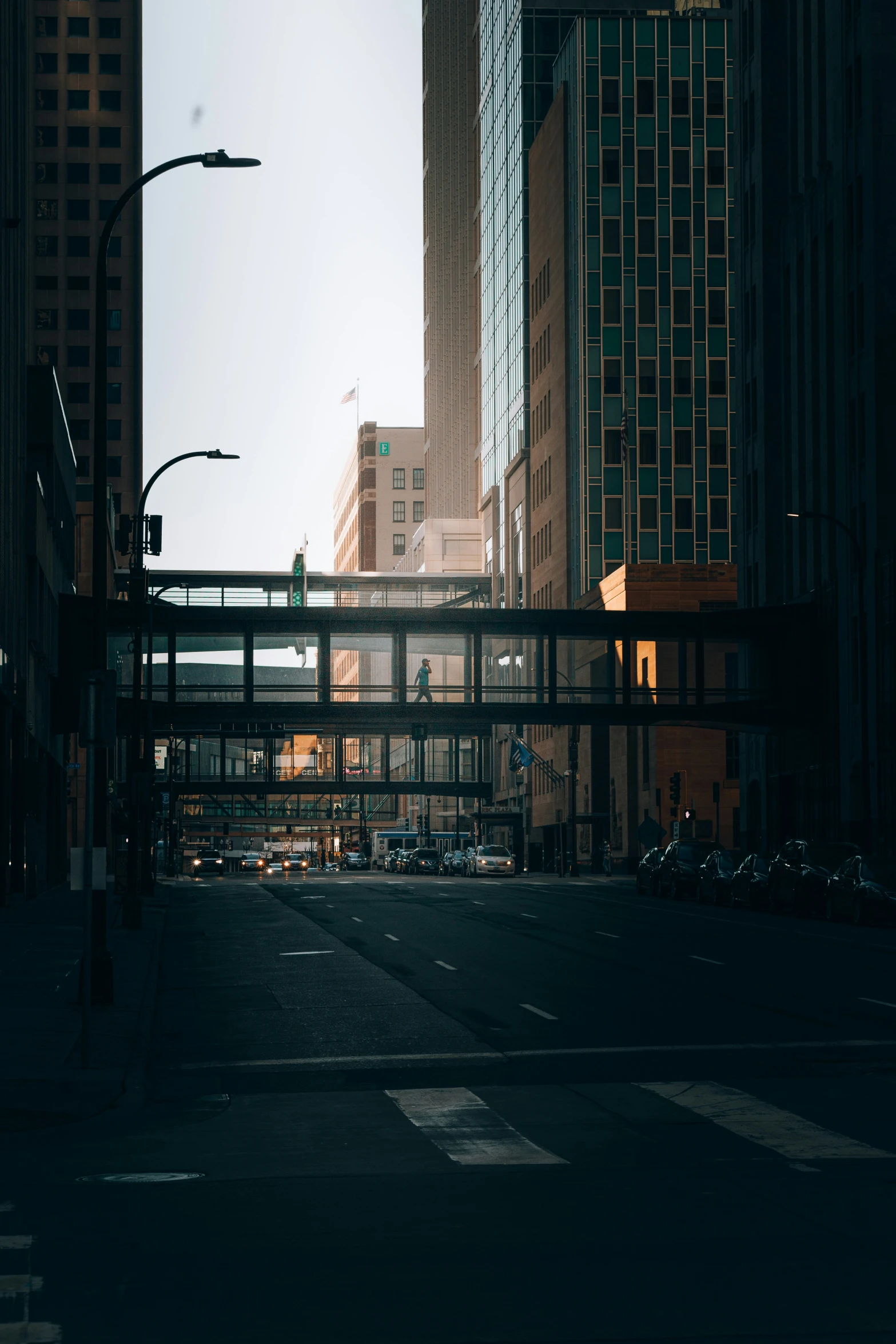 city street with tall buildings next to an empty street