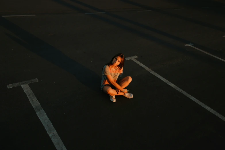 girl sitting on the ground looking at her cell phone