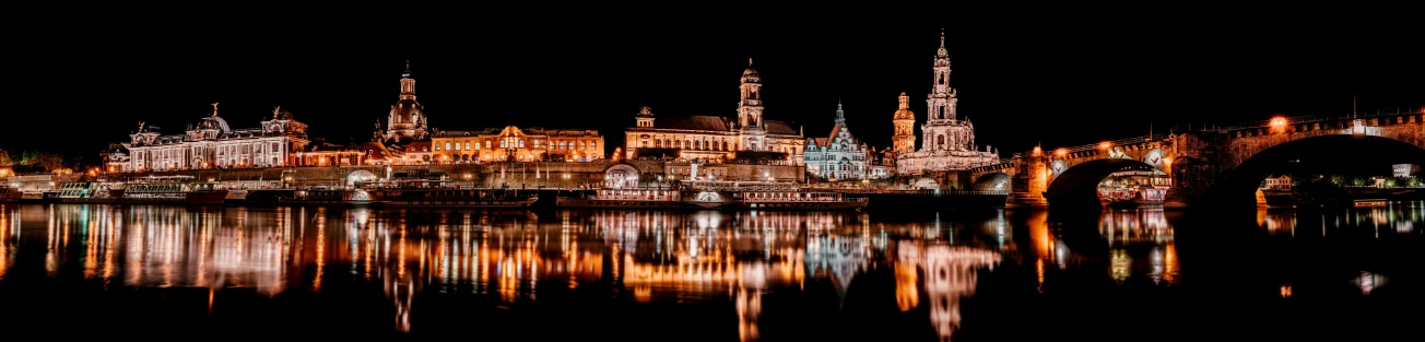 a view of the city that is reflected in the water