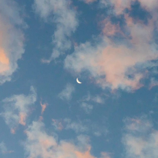 clouds that are very blue with a small moon