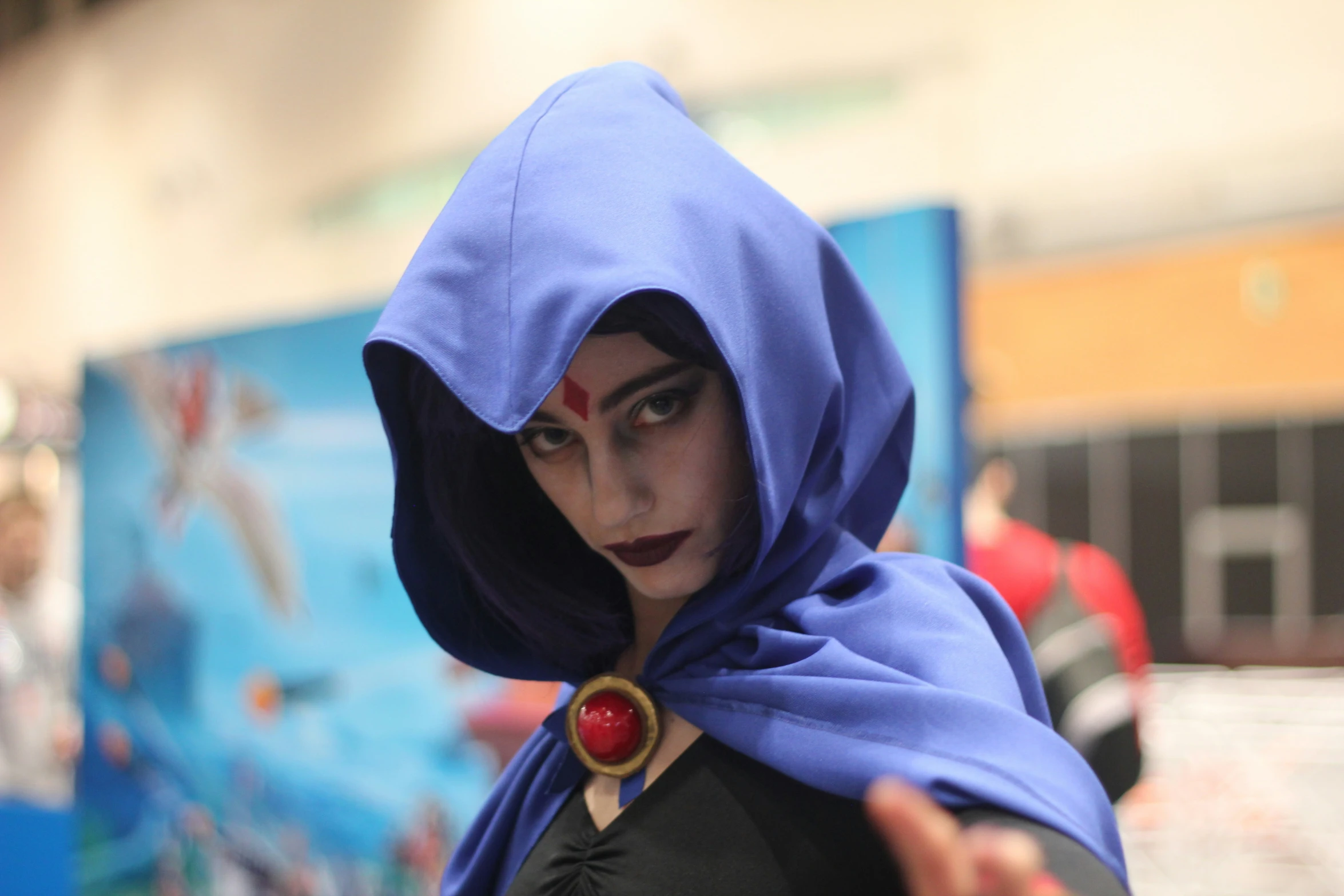 a person in a costume has a blue cloak