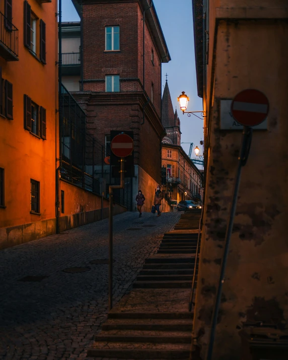 a dimly lit alley with several building in the background