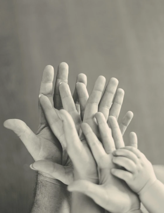 several hands and fingers stacked on top of each other