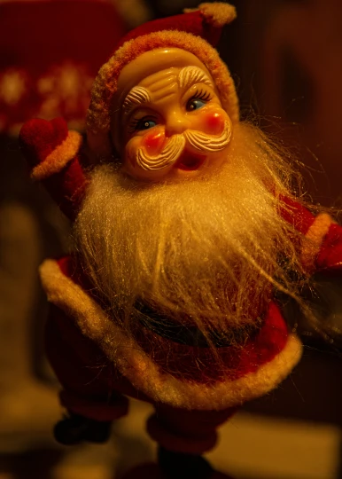 there is a figurine of a santa with a beard and red hat