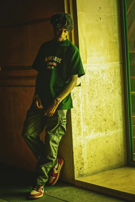 the young man stands beside a large building