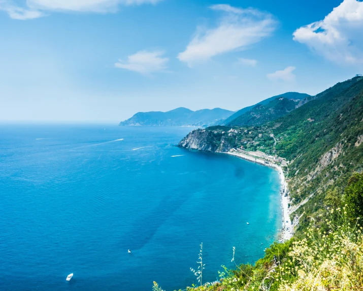 a view of a cliff with a blue ocean below