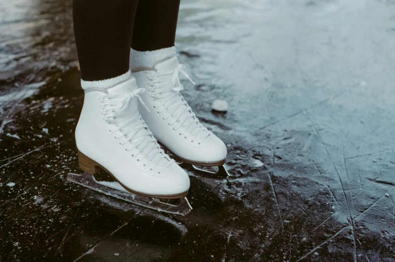 the skates are white in color and on the ground