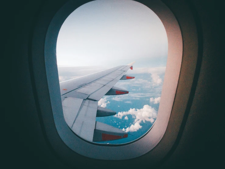 an airplane's wing is looking out at the sky