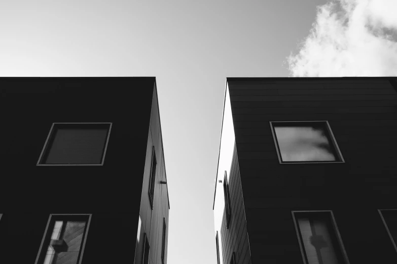 two tall building next to each other with windows