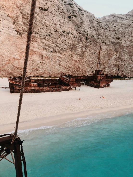 a boat is parked on the beach at low tide