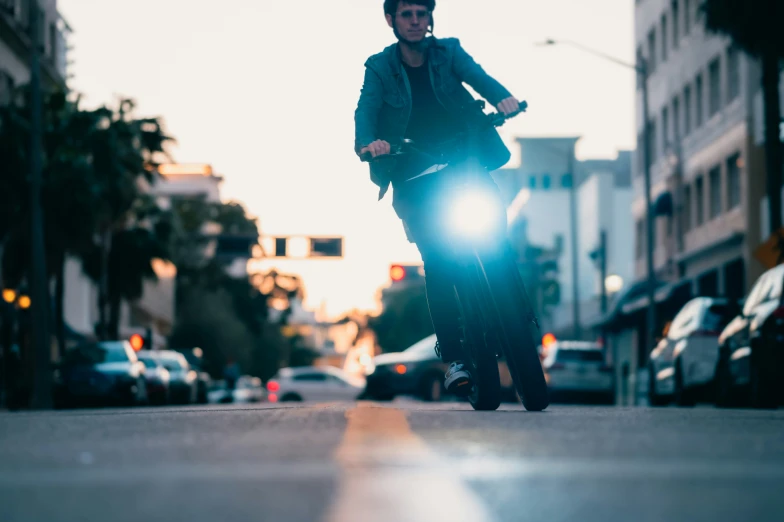 a man riding a scooter with his hands on the handle