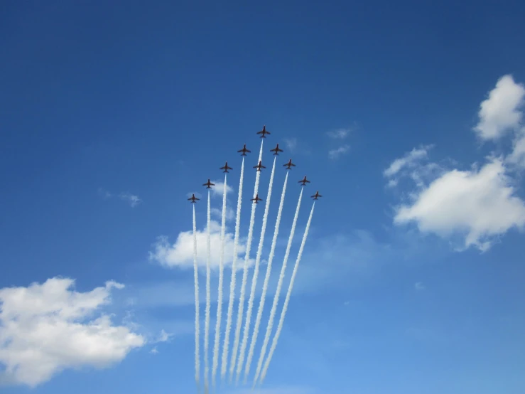 a squadron of airplanes fly together in the sky