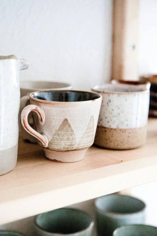 a counter with several dishes and coffee pots on it