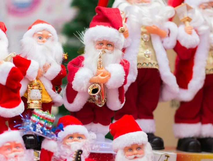 several santas standing next to each other in their christmas costumes