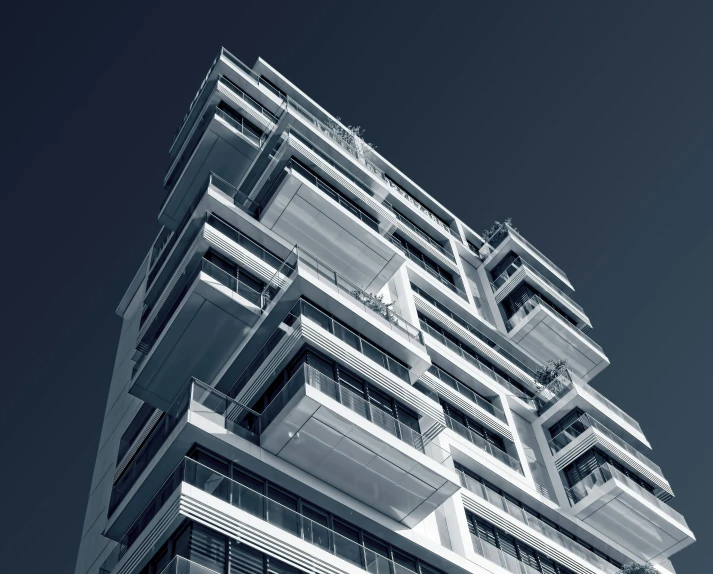 an upward view of an architectural structure against a grey sky