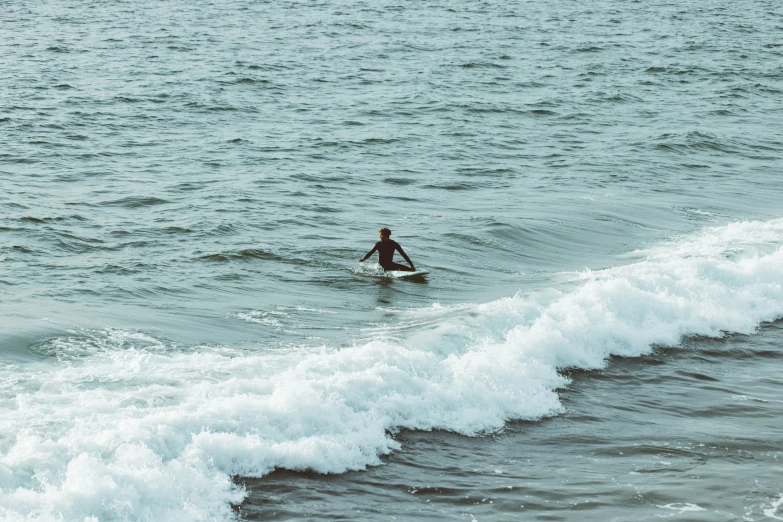 a man standing on a surfboard in the water