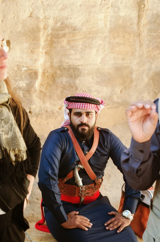 three men dressed in costume standing around one another