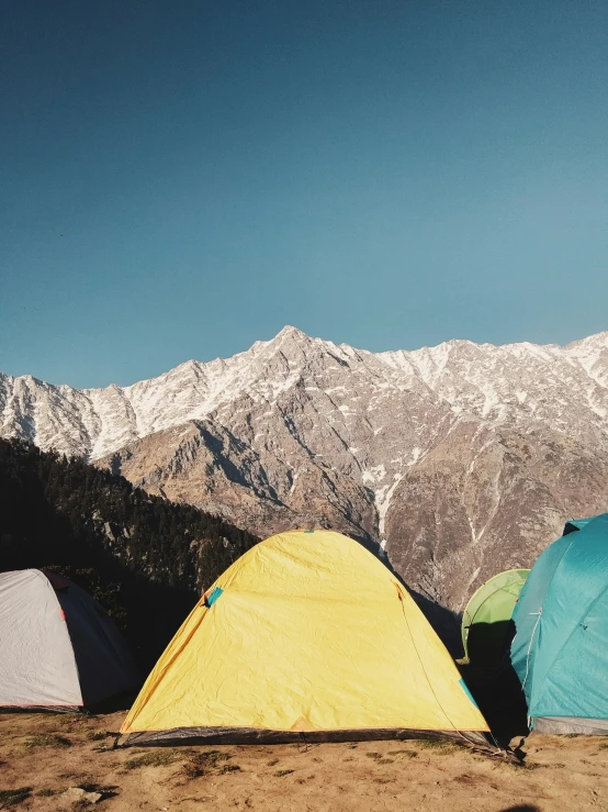 a group of tents pitched up on top of a mountain