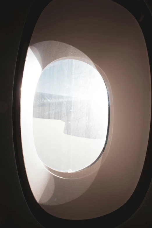 an airplane window with a circular shape and the window has no visible