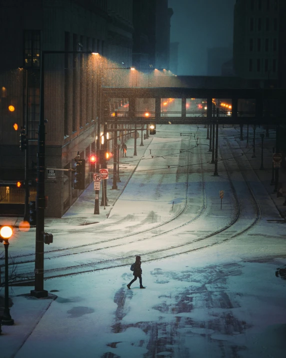 a person standing alone in the snow at night