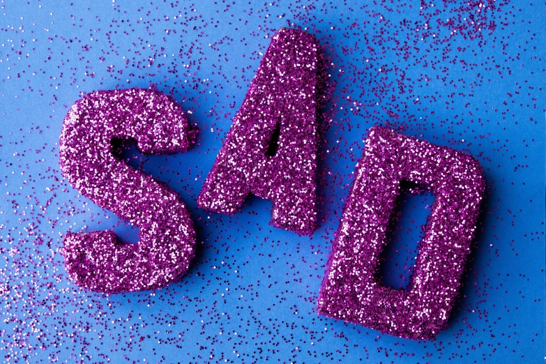 the word yes spelled out in purple glitter