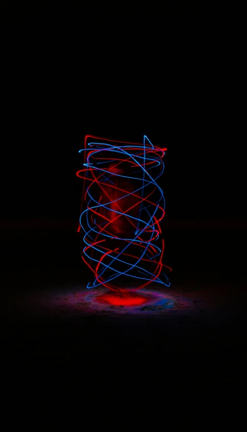 blue and red light spinning on dark ground