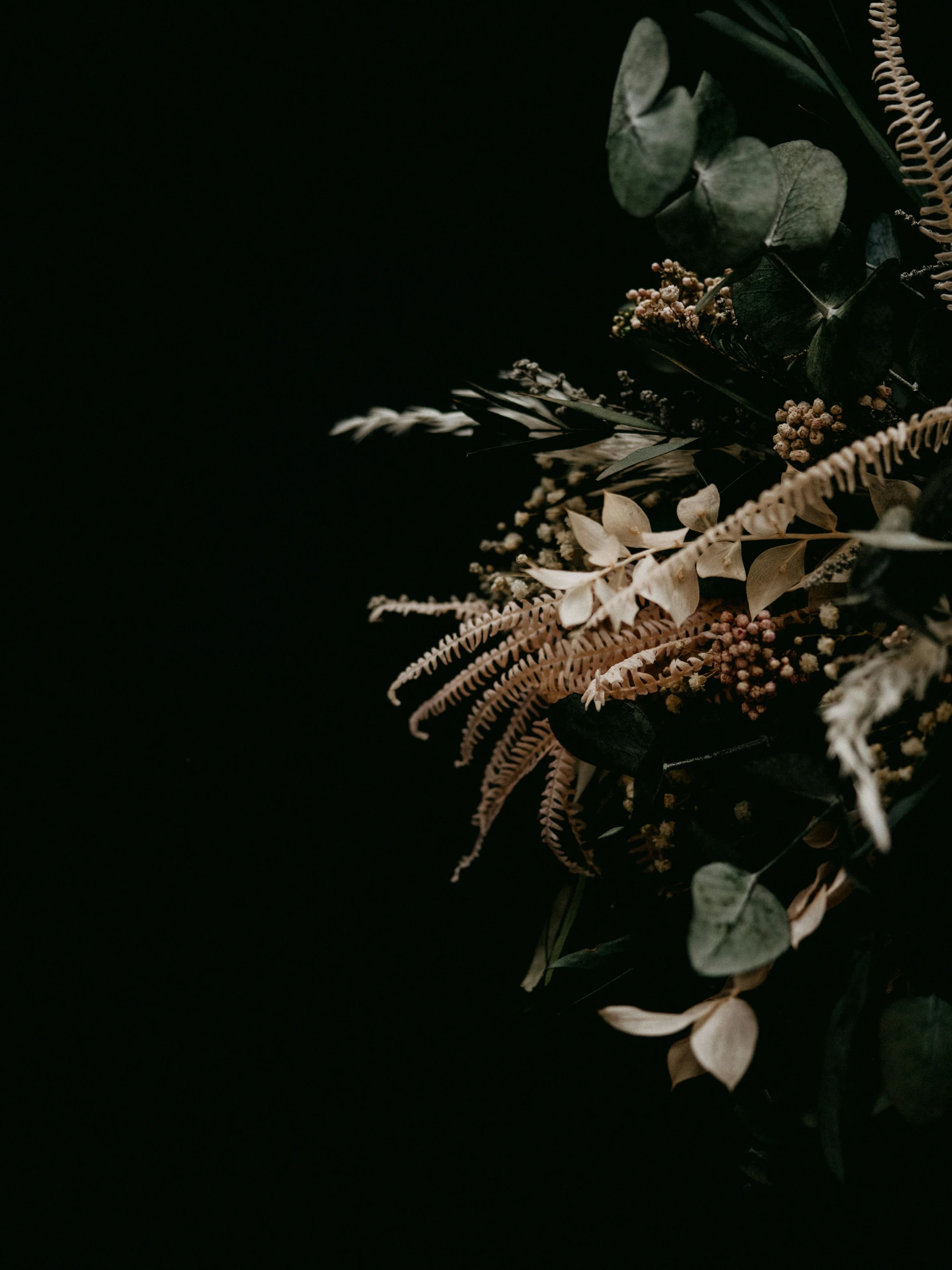 a black po of various green flowers in the dark