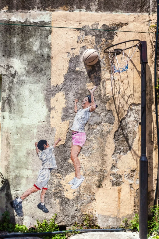 two young men playing with a ball near a basketball court