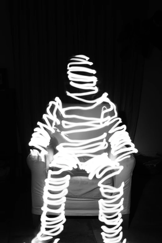 the shadow of a seated man made out of light and material