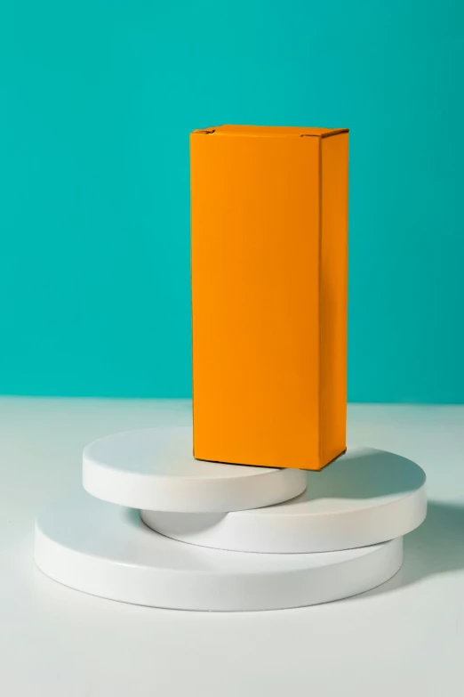 the orange paper is on top of white round pedestals