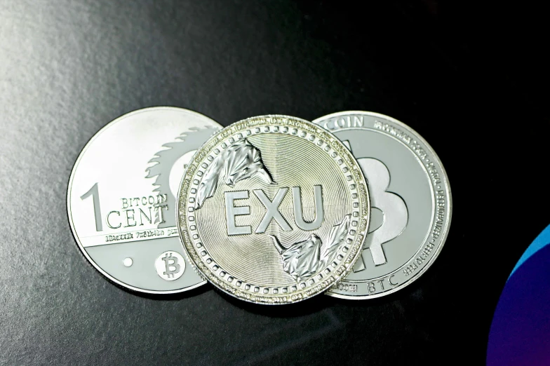 silver coins lying on top of a table