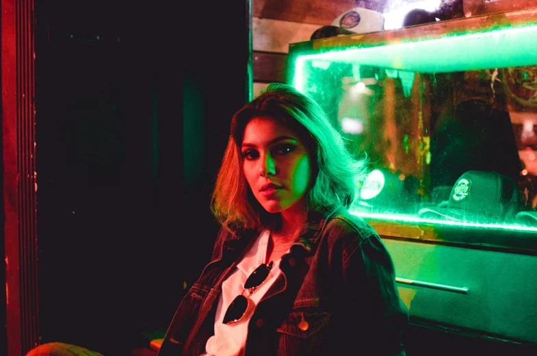 woman with bright green light sitting in front of laptop